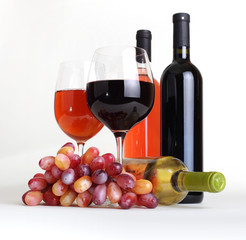 wineglass, bottles of wine and grapes