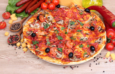 delicious pizza, vegetables and salami on wooden table