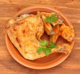 roasted chicken wings and leg with parsley in the plate