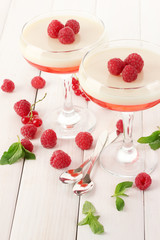 fruit jelly with berries in glasses on wooden table