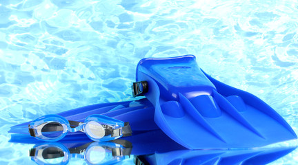 blue flippers and goggles on blue sea background
