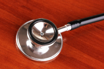 Stethoscope close-up on brown wooden table