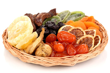 Dried fruits on wicker plate isolated on white