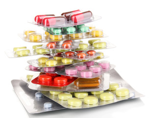 Capsules and pills packed in blisters isolated on white