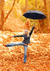 Sweet girl jumping with umbrella