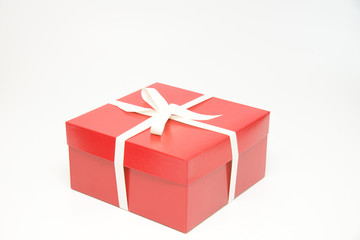 Red gift box with white ribbon and bow