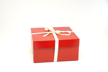 Red gift box with white ribbon and bow