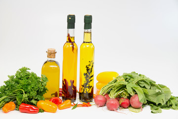 Olive oil in bottle with peppers and vegetable