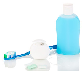 Toothbrush, chewing gum and dental floss isolated on white
