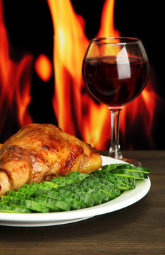 Roast chicken with french fries and cucumbers, glass of wine