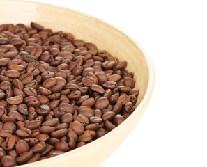 Coffee beans in bamboo bowl isolated on white