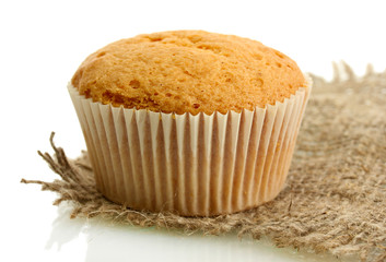 tasty muffin cake on burlap, isolated on white