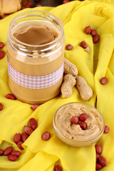 Delicious peanut butter in jar with baking