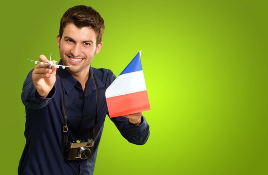 Man Holding A Miniature Airplane And French Flag
