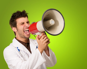 Portrait Of A Male Doctor Shouting On Megaphone