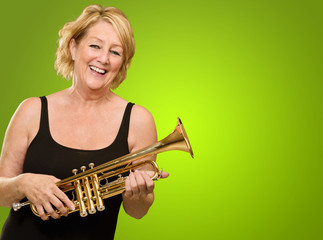 Happy Mature Woman Holding Trumpet