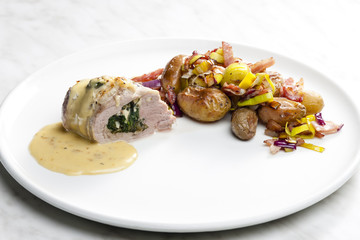 baked pork tenderloin filled with spinach and goat cheese on cre