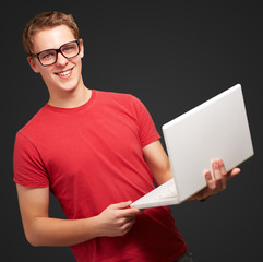 Happy man holding laptop