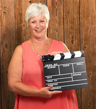 Senior Woman Holding Clapper