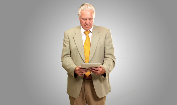 Portrait Of A Senior Man Working On A Laptop