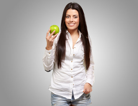 Woman showing green apple