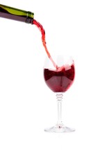 Red wine pouring into wine glass