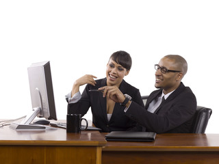 happy business partners in front of computer