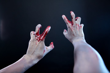 Zombie stretching bloody hands