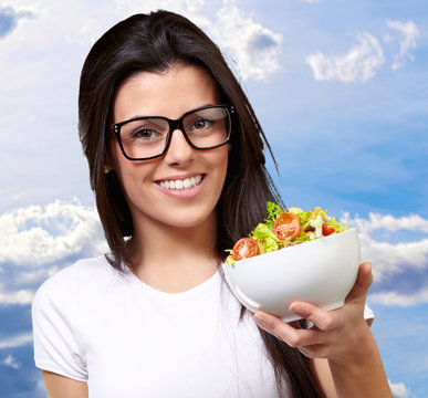 Young Girl Showing A Bowl Of Salad