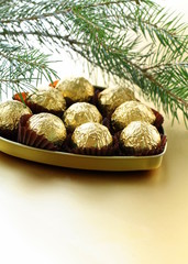 chocolate truffles in a gift box under the Christmas tree