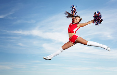 Fototapeta na wymiar Young female cheerleader