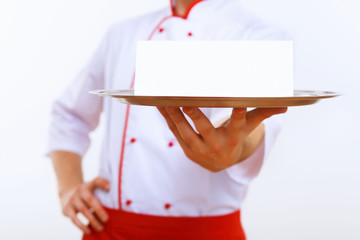 Cook holding an empty tray