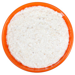 traditional english oat porridge with milk in orange bow