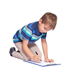 Boy writes in his diary. Isolated over white background.