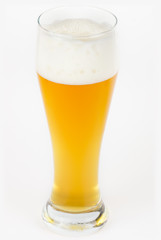 A glass with unfiltered beer on white