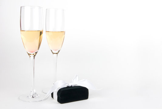 Two champagne goblets with jeweller box on white