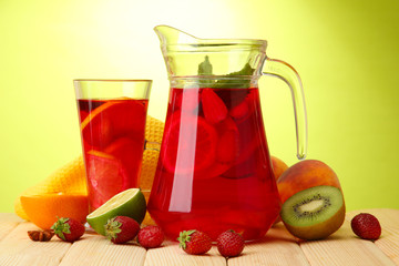 sangria in jar and glass with fruits,