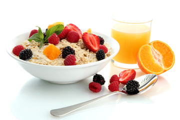 tasty oatmeal with berries and glass of juice, isolated on