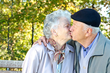 Beautiful senior couple kissing in autumn