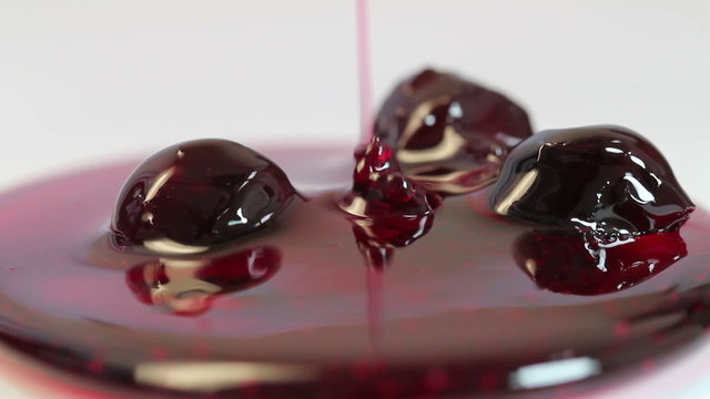 bottled cherry jam on a white background