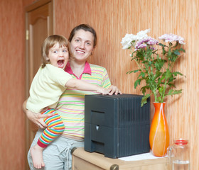 Woman and child uses humidifier