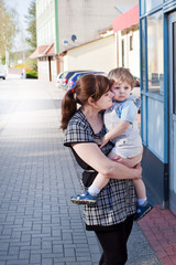 Young mother and toddler boy on city street