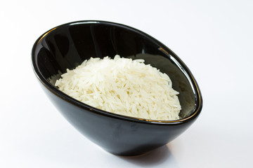 Basmati rice in black pot isolated on white background