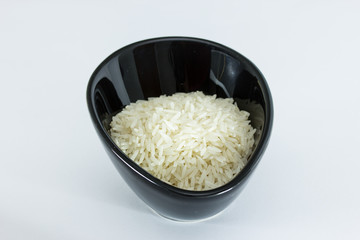 Basmati rice in black pot isolated on white background