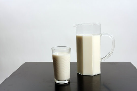 Glass full of milk and milk jar, healthy drink