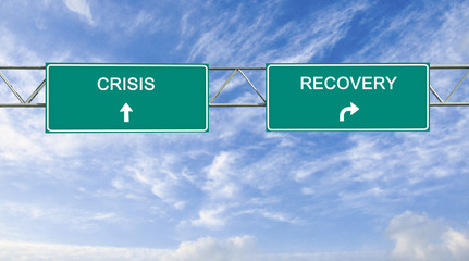 Road sign to recovery and recession