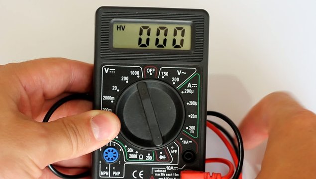 Man measures digital multimeter