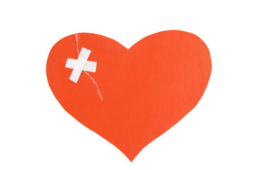 Broken heart concept: paper heart torn and fixed with plaster