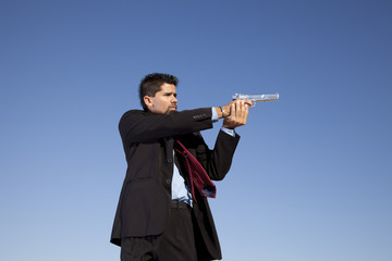 Businessman aiming a handgun