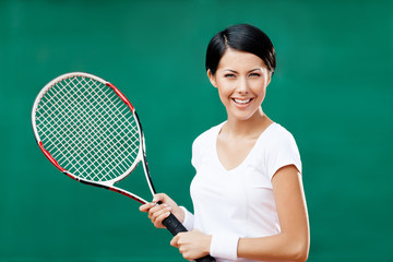Portrait of successful female tennis player with racquet